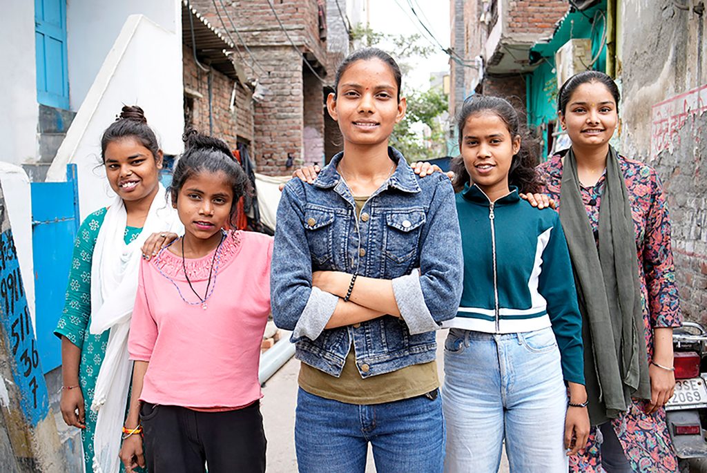 Five girls confidently standing in a row