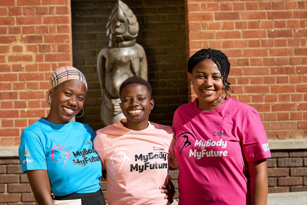 Three young women pose for the camera wear t-shirts that say 'my body, my choice'