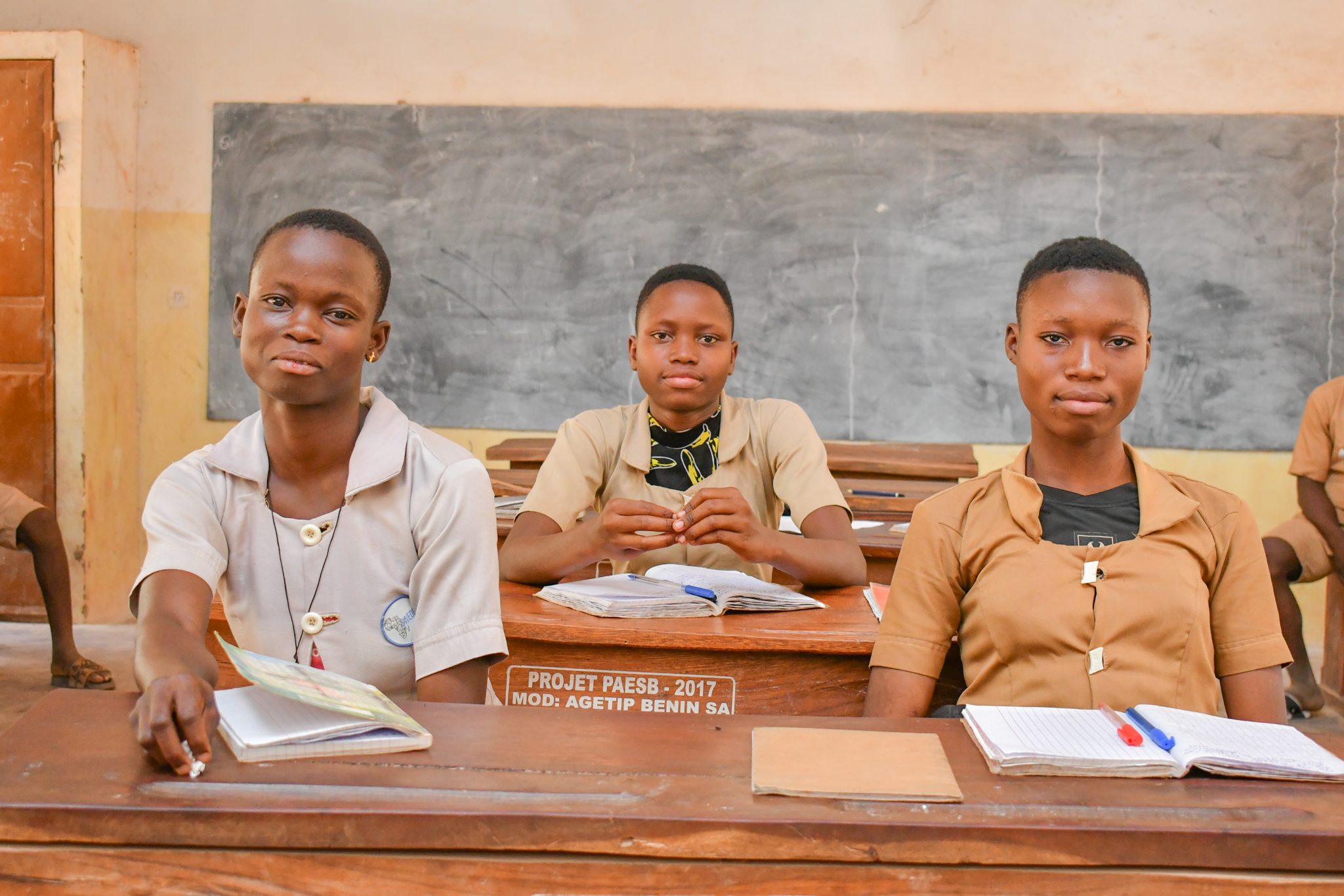 Few girls members of the football club in classroom